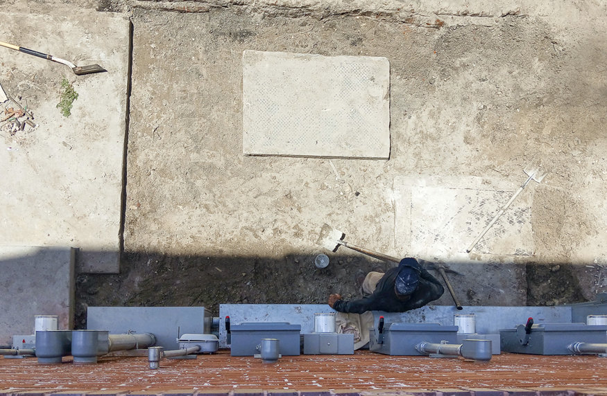 A crew member inspecting the ground before the concrete is poured