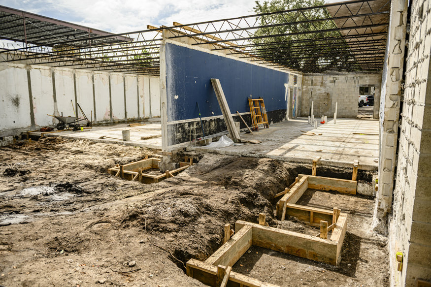 Wood forms outline excavated footing areas.