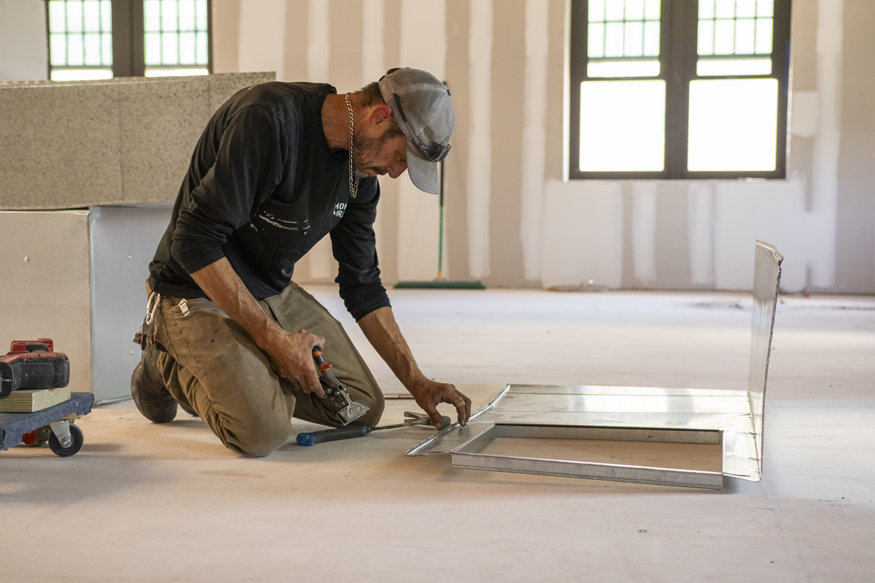 Technician custom creates sheet metal duct section for Air handler unit.