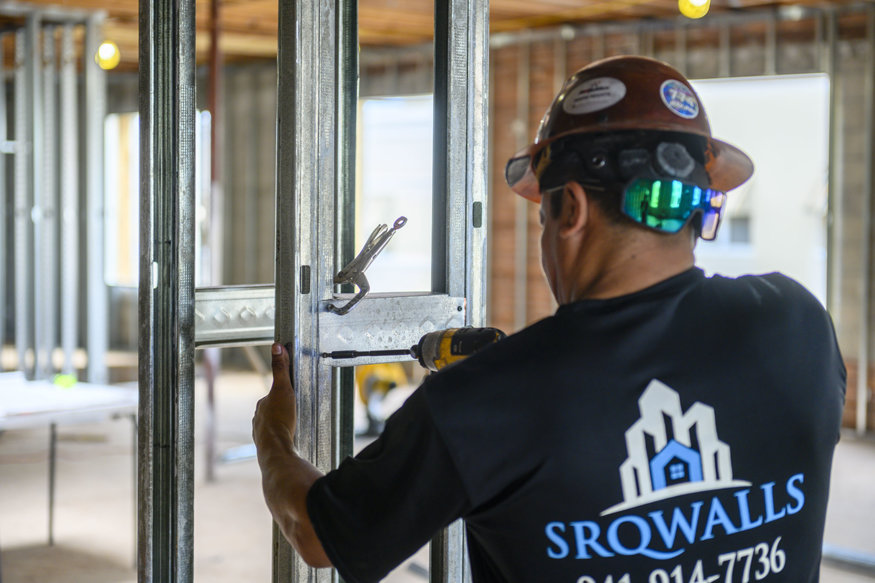 Metal bracing is attached to a framed beam.