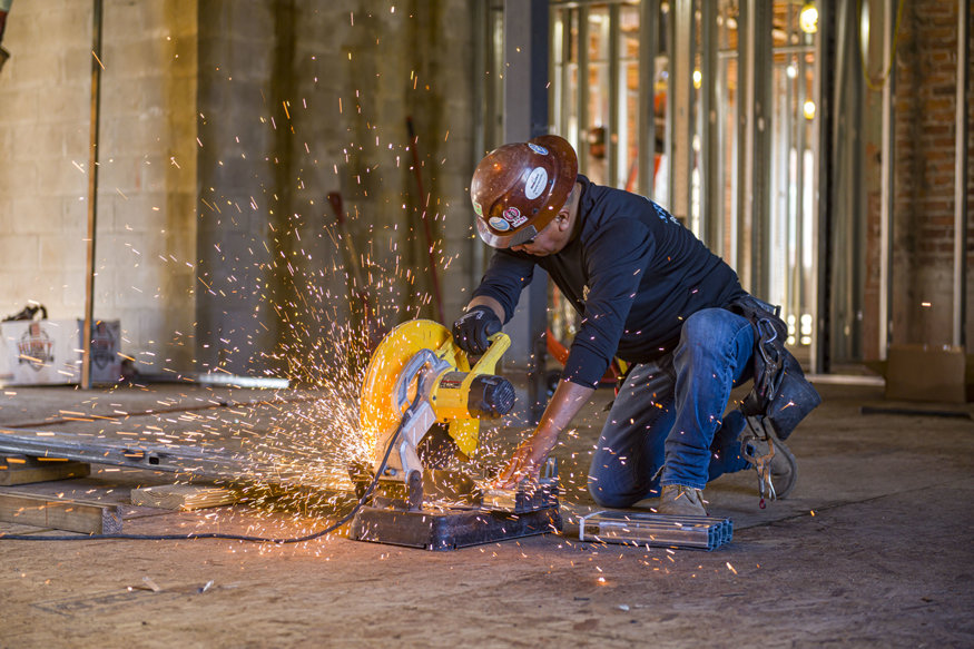 Crew member cutting the framing to size.