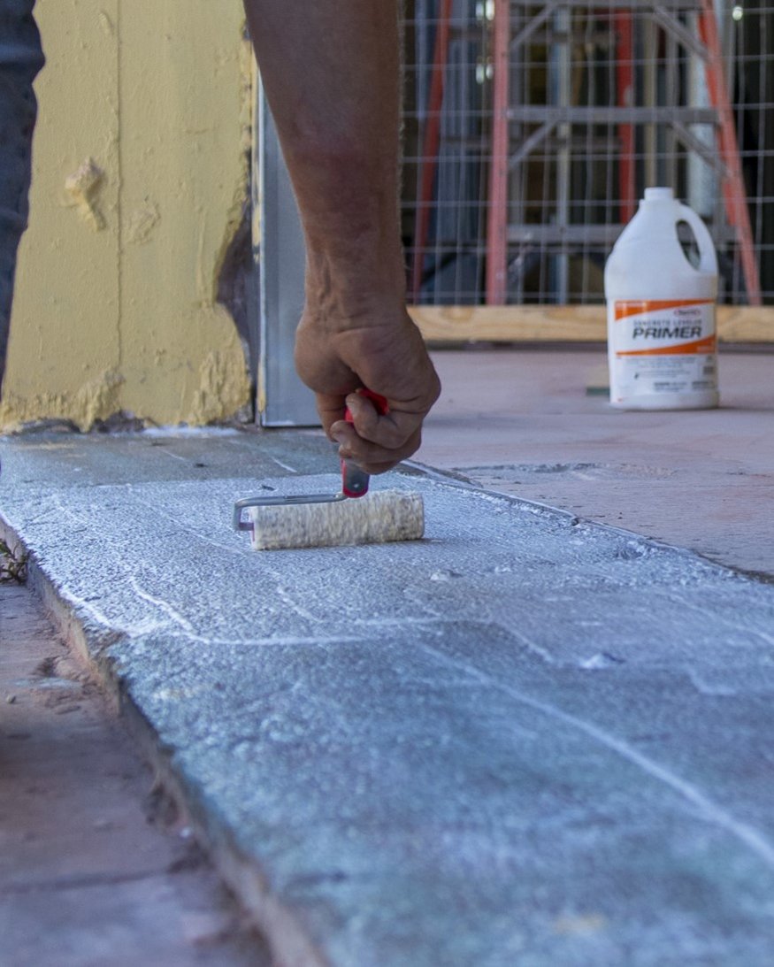 Priming concrete surface.
