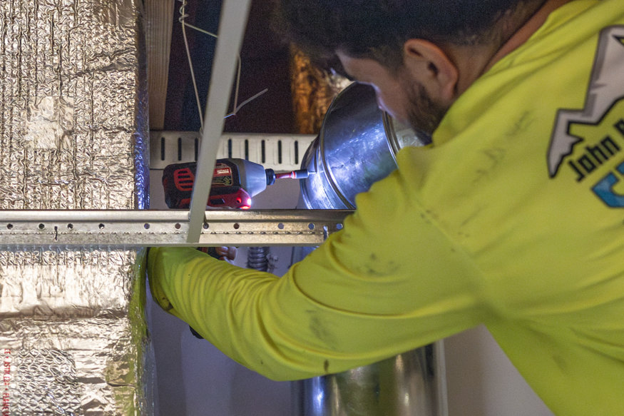 Workers connecting ducting.