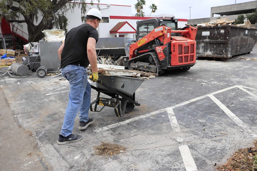 Crews remove debris from the Brown Brothers building.