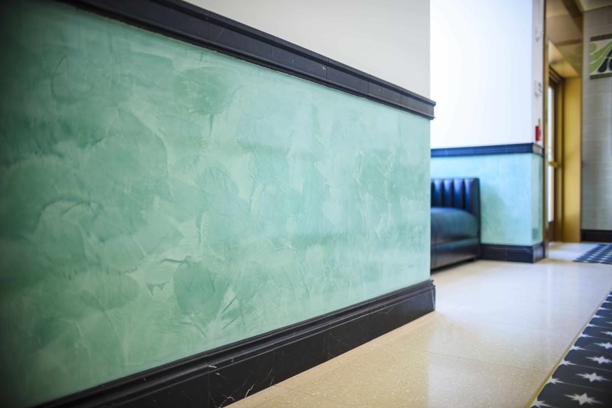 Detailed view of hand-troweled Venetian plaster wainscoting in Peoples Bank interior. 