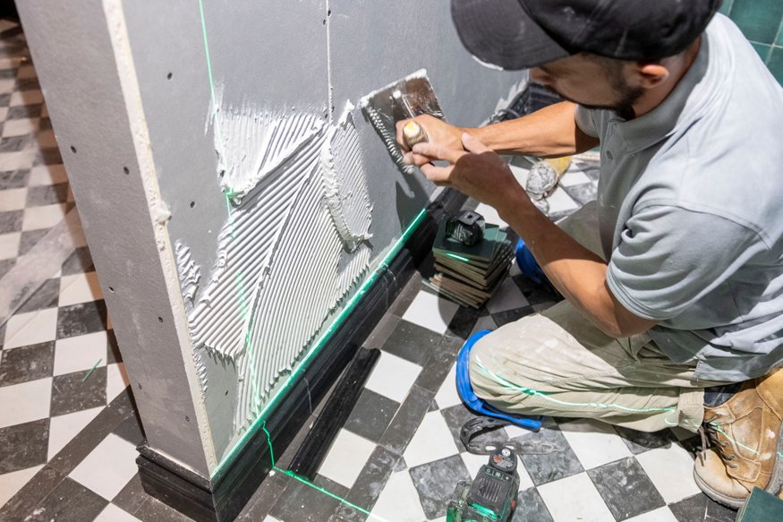 Crew applying thin-set mortar for tile installation.