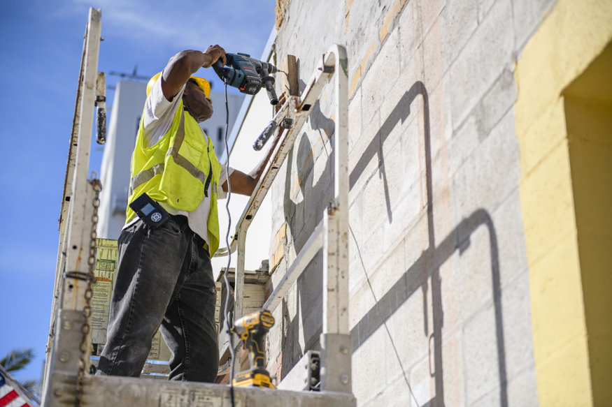 Crew member securing the block that holds the string line.