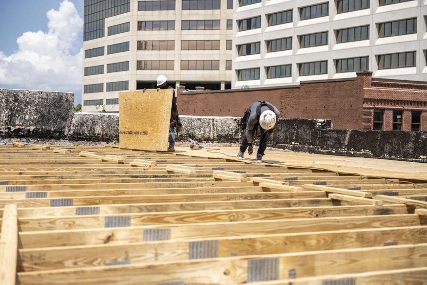 Decking being installed on roof trusses.