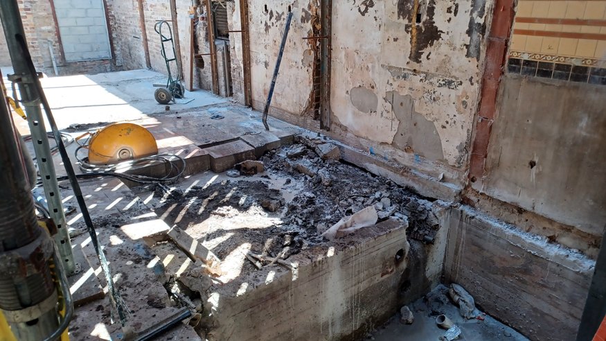 Cleared slab area exposing dirt below.