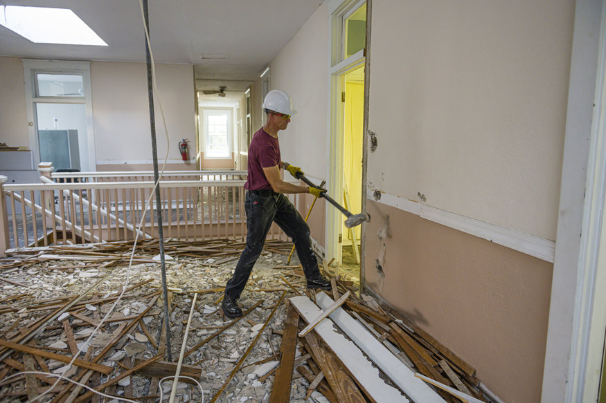 A hammer was used to open up the lath wall.