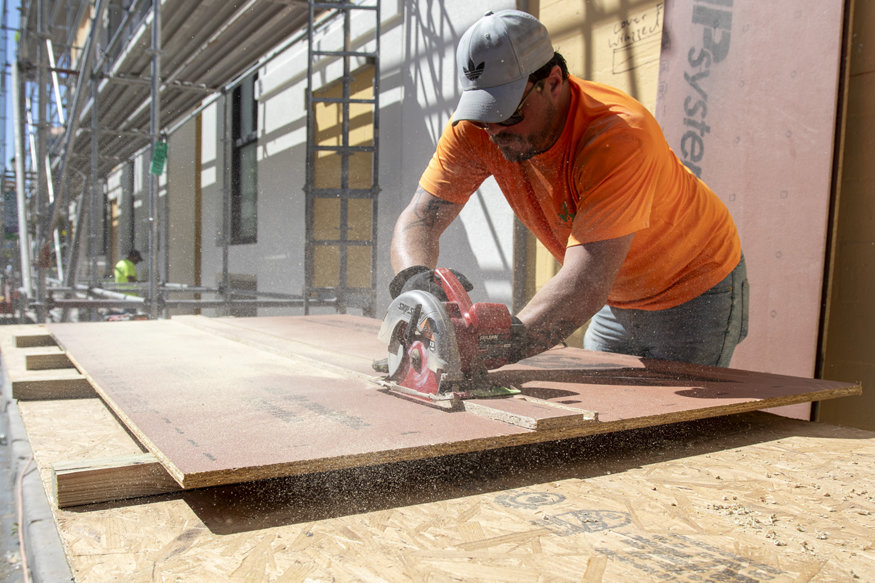 Plywood is sawed ahead of installation.