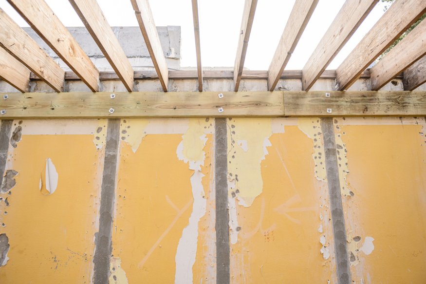 Wood ledger secured to CMU wall with bolts.