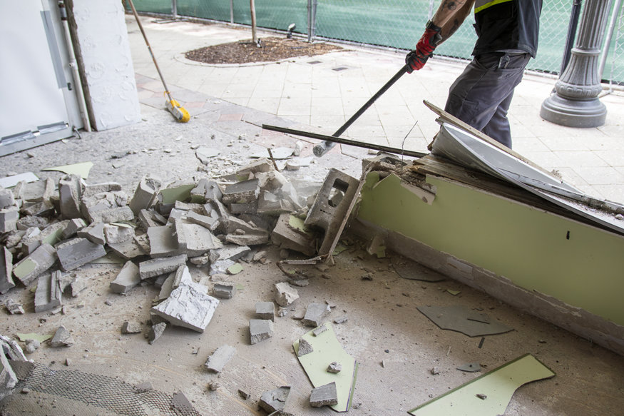 Debris from knee wall demolition on floor.