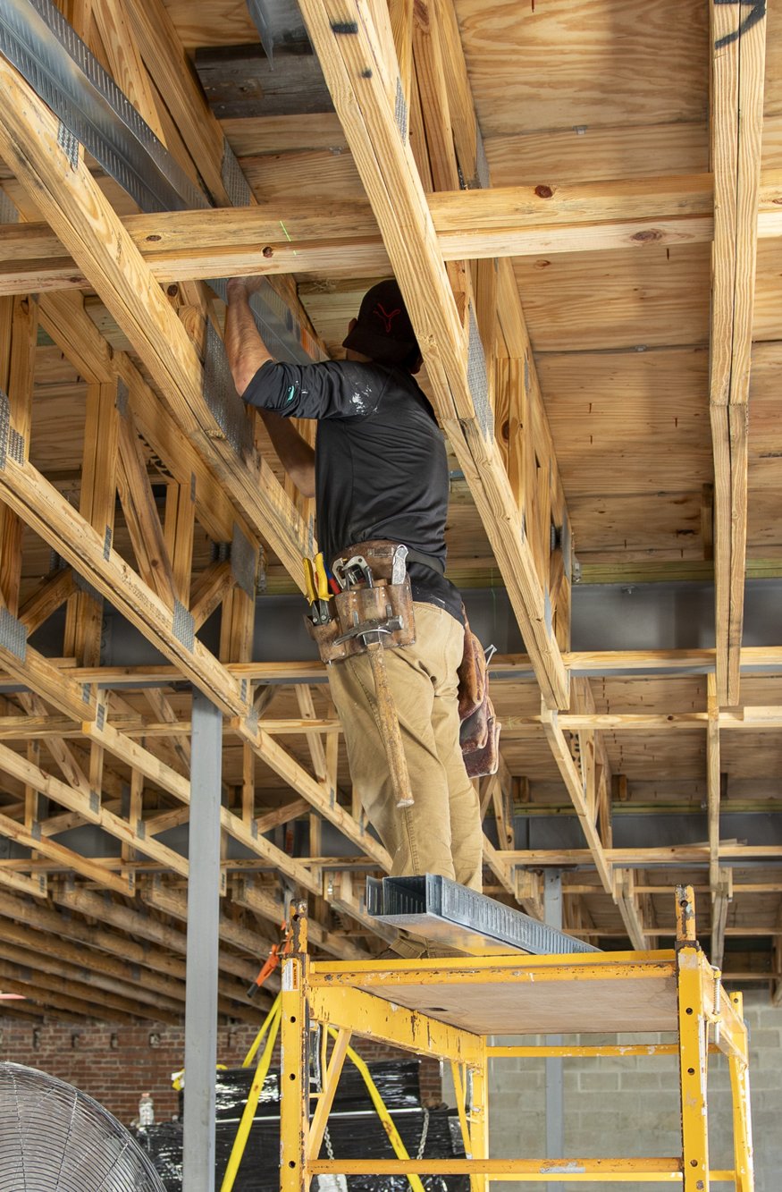Track framing is fixed to the roof trusses.