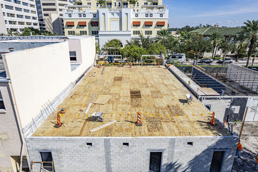 New plywood decking covers roof framing.