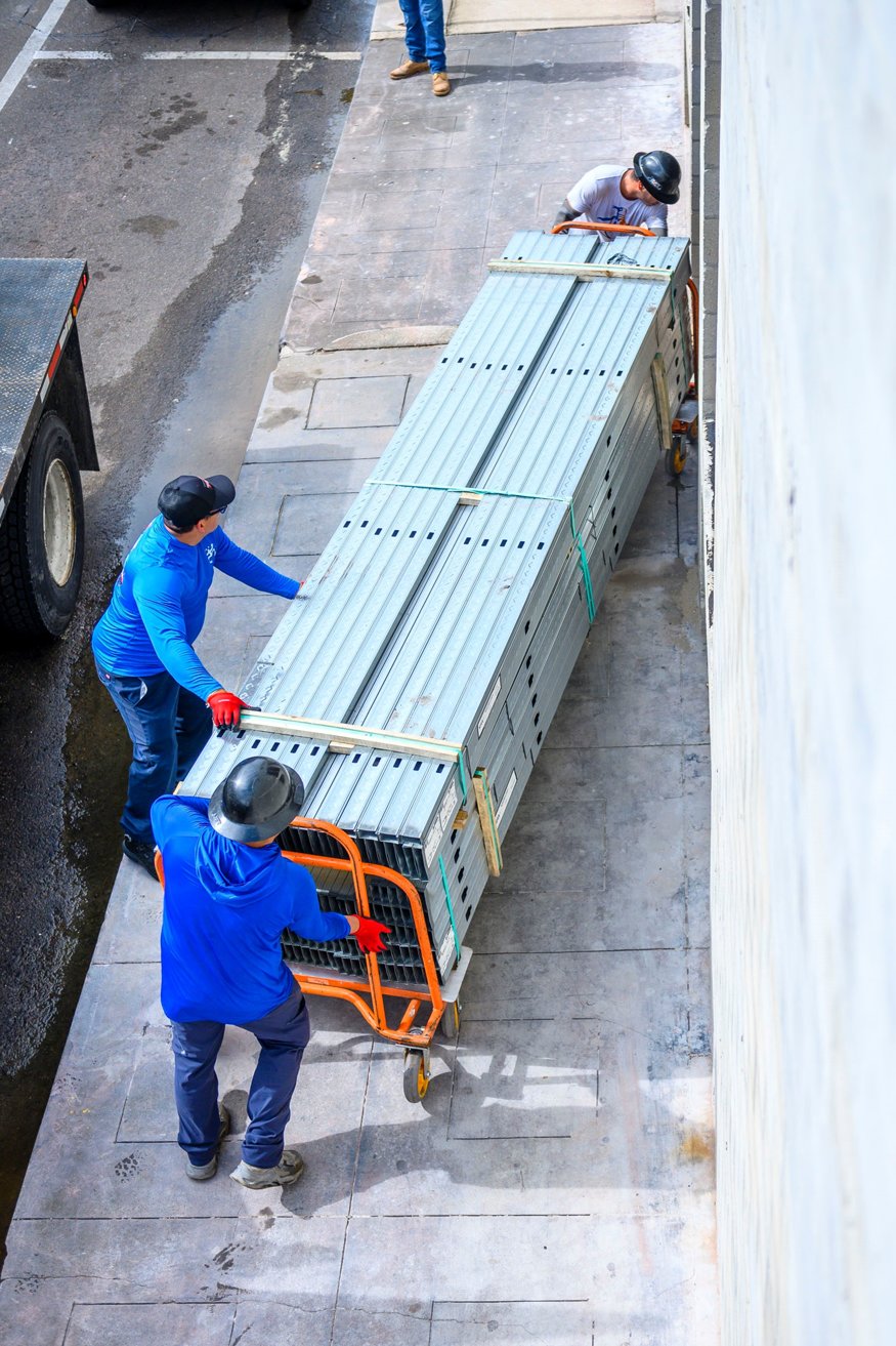 Framing pallets being wheeled inside.