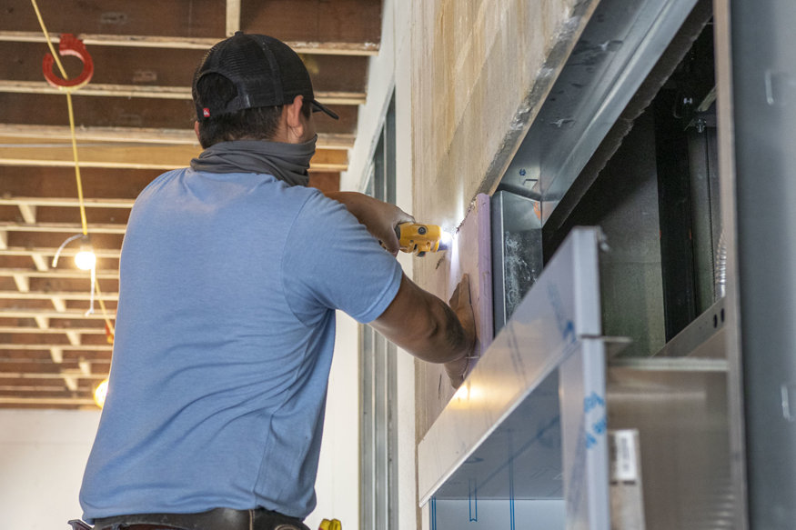 Drywall around elevator frame.