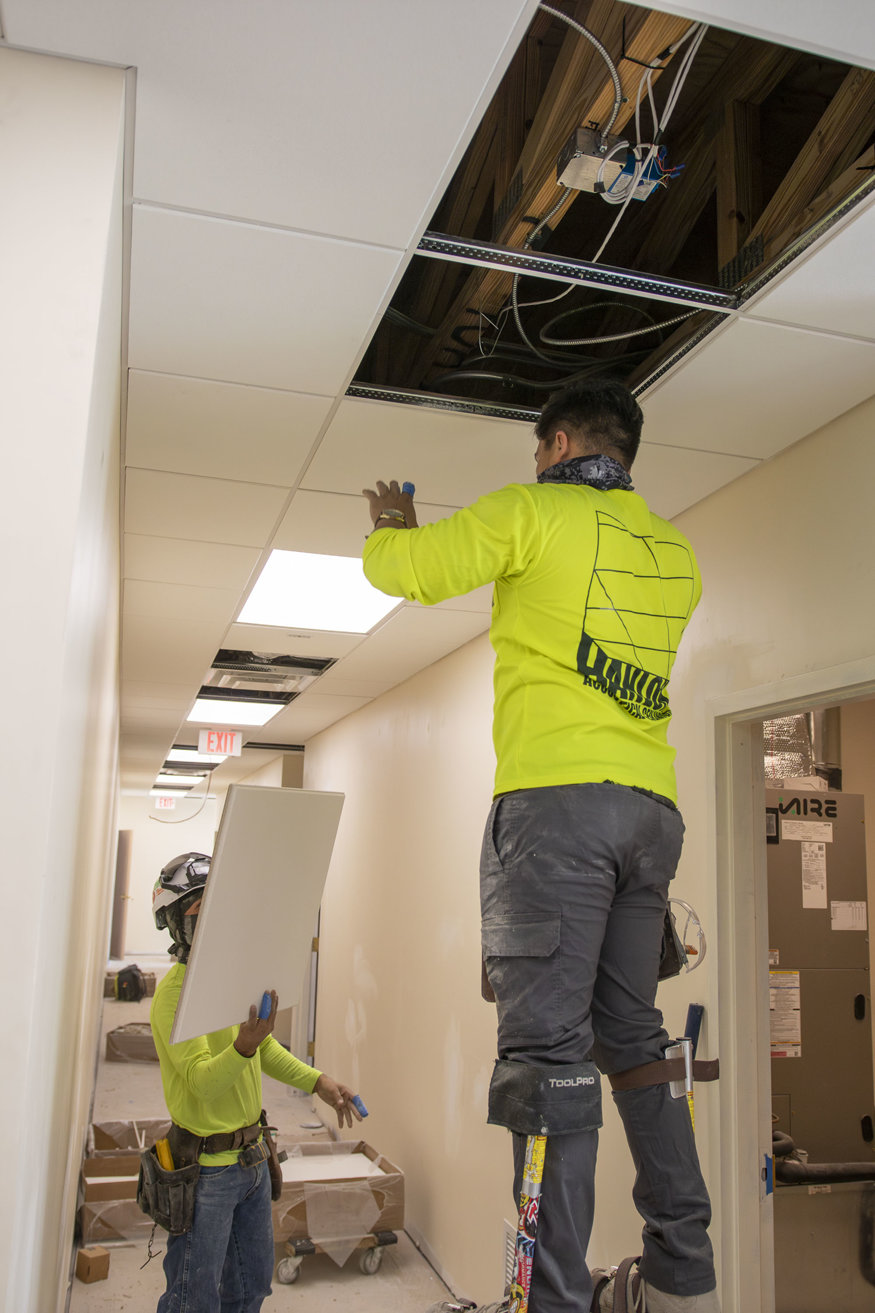 Installed ceiling tiles overhead.