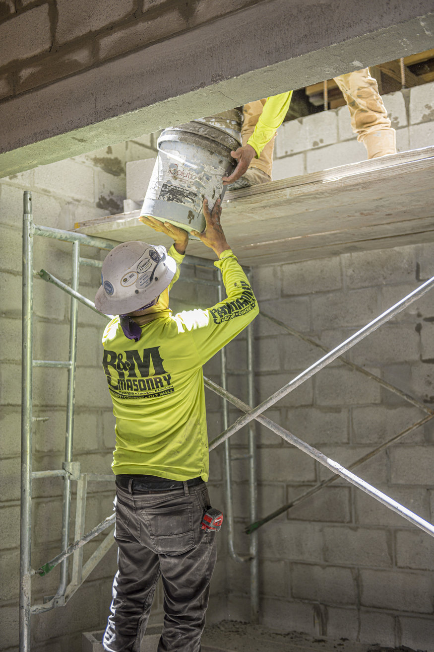 Worker constructs elevator shaft walls inside the Peoples Bank.