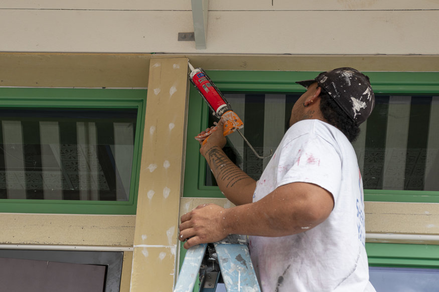 Caulking around trim.