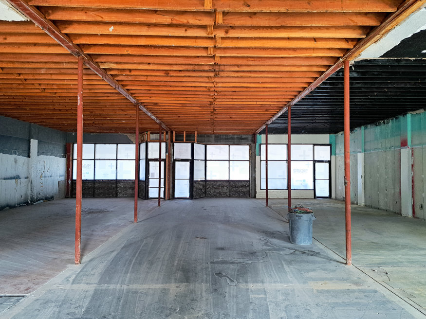 Interior of 645 Cleveland Street showing exposed original wooden framework and cleared space after demolition.