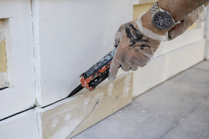 Caulking applied to exterior panel framing joints.