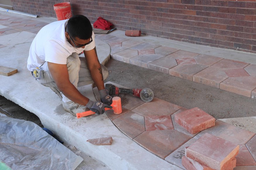 Careful placement continues as the paver layout is completed.