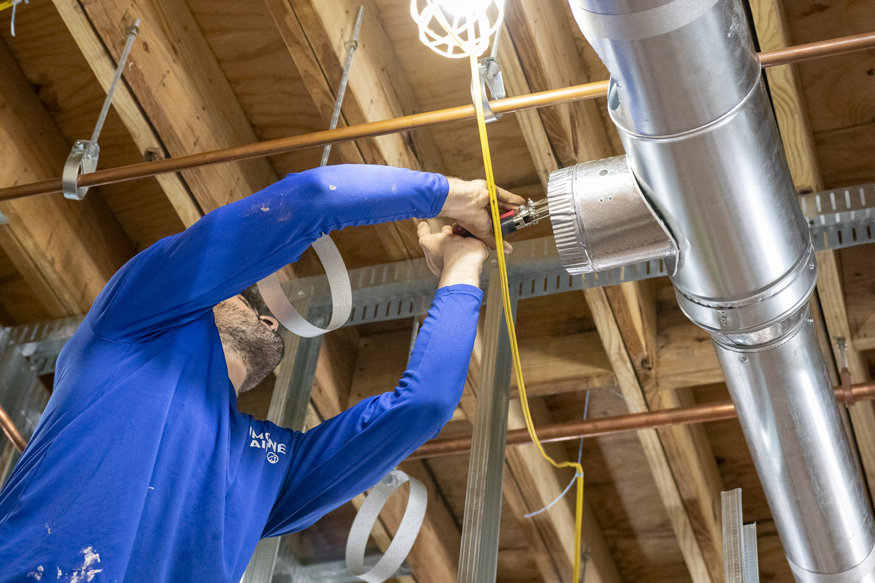 Crew attaching ductwork together.