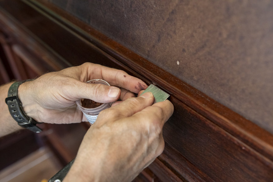Repairing woodwork with putty.