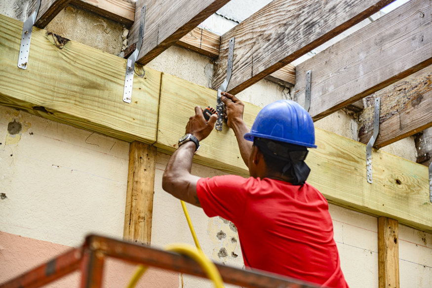 Hurricane ties connect roof joists to ledger board.