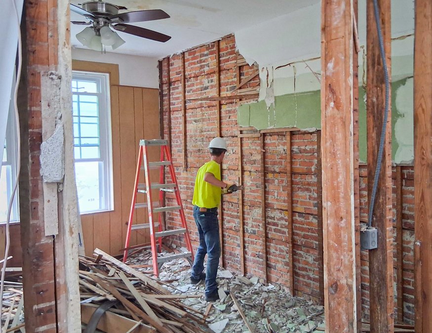 Original brick revealed on wall.