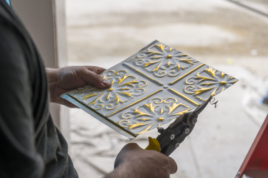 Close-up of tin tile alignment in ceiling frame.