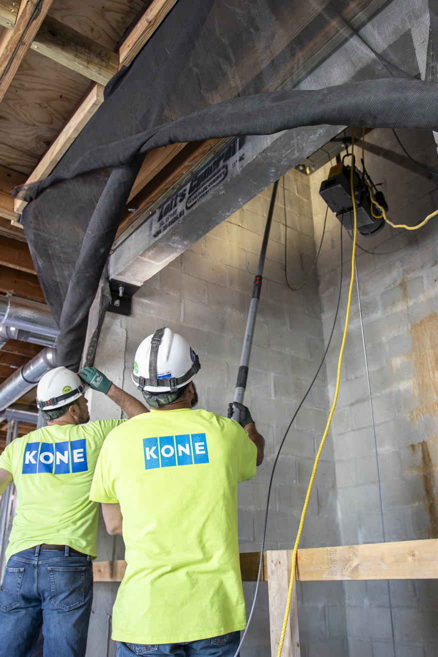 Installing elevator wiring to power the motor.