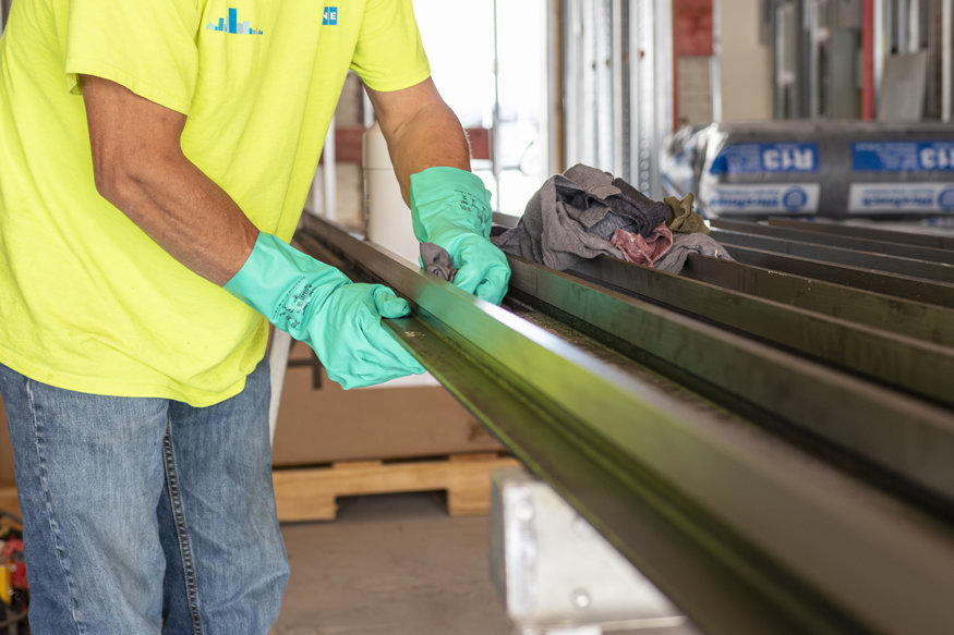 Guide rails are cleaned with a solution and rags.