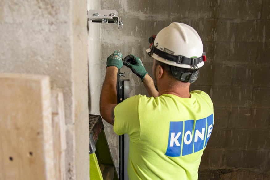 Crew members install the guide rails.