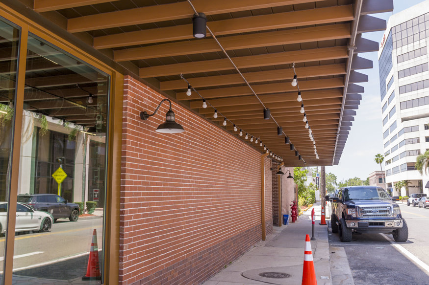 Electrician-installed lights under the Telephone Building awning.