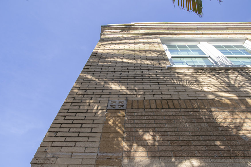 Detailed view of original yellow brick surface newly exposed through restoration paint stripping.