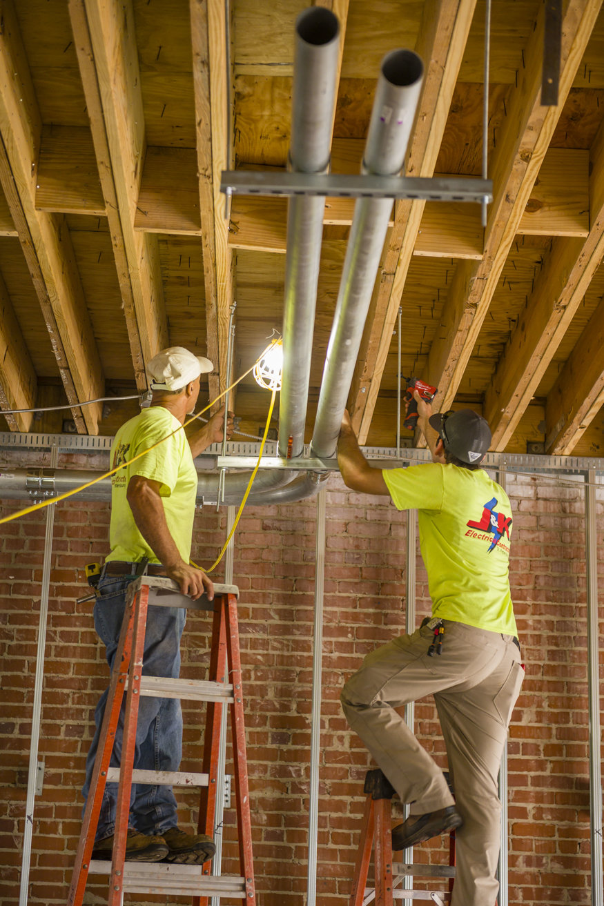 Overhead conduits are secured across the ceiling frame.