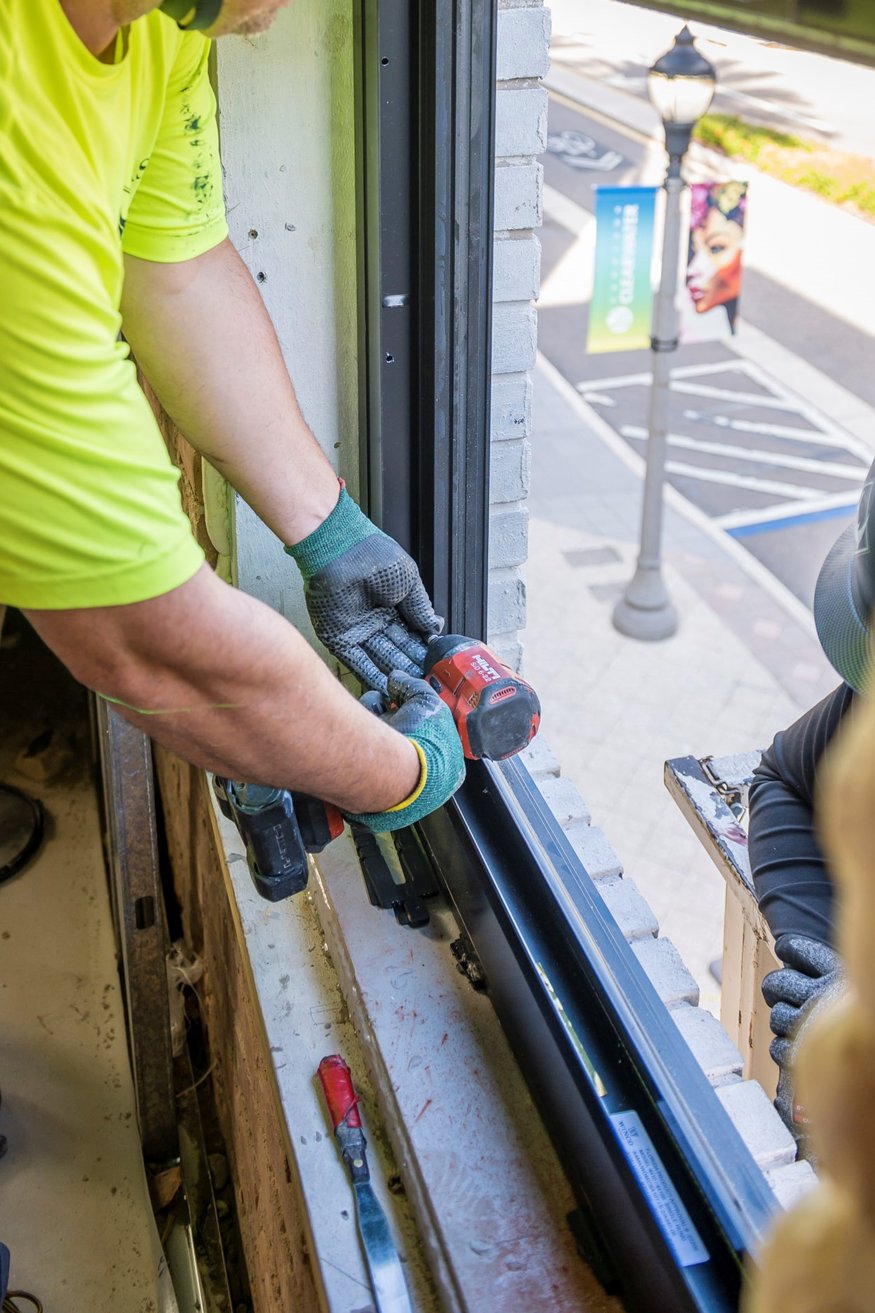 Close-up of historic-style windows being installed.