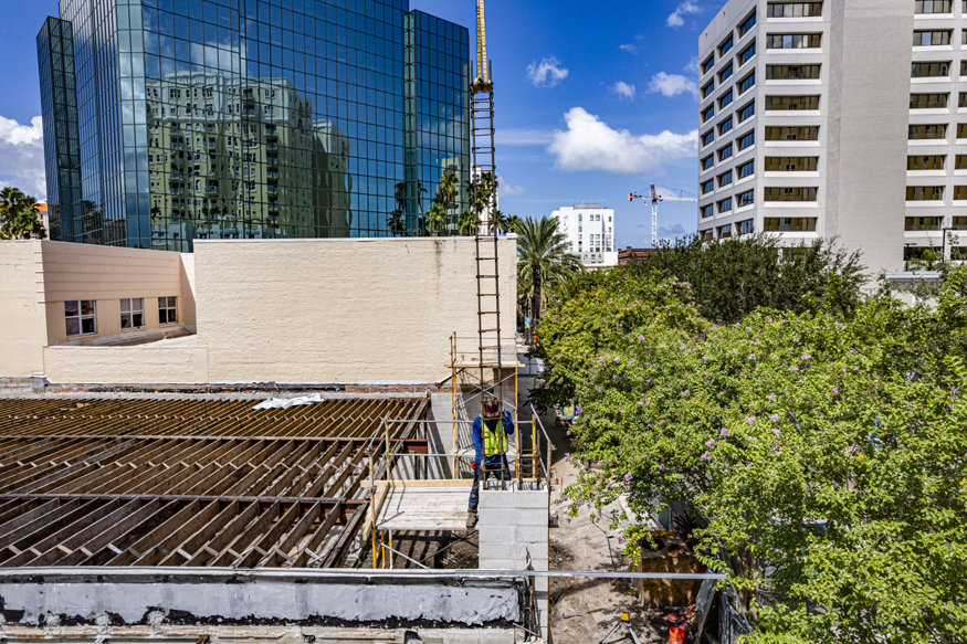Worker guides rebar cage into front column.