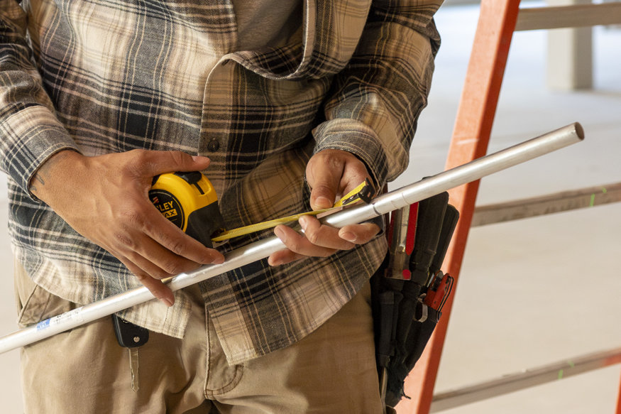 Crew measuring conduit for the second floor.