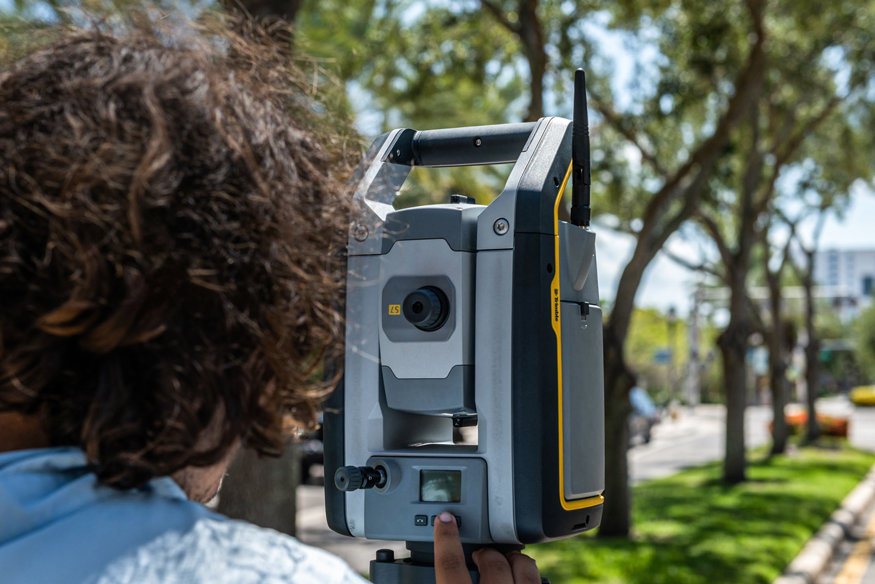Surveyor operating a Trimble total station on the 600 Block.