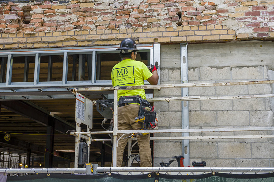Continuous soffit framed above storefront at Woolworth.