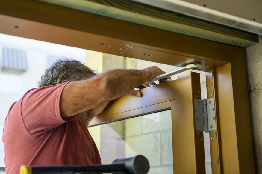 Installing door hardware at entry.