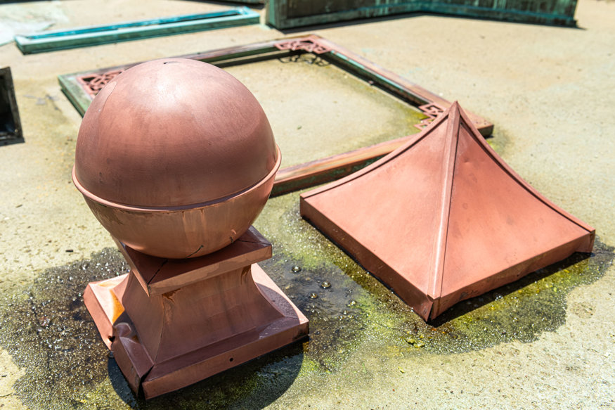 Copper clock components drying after cleaning.