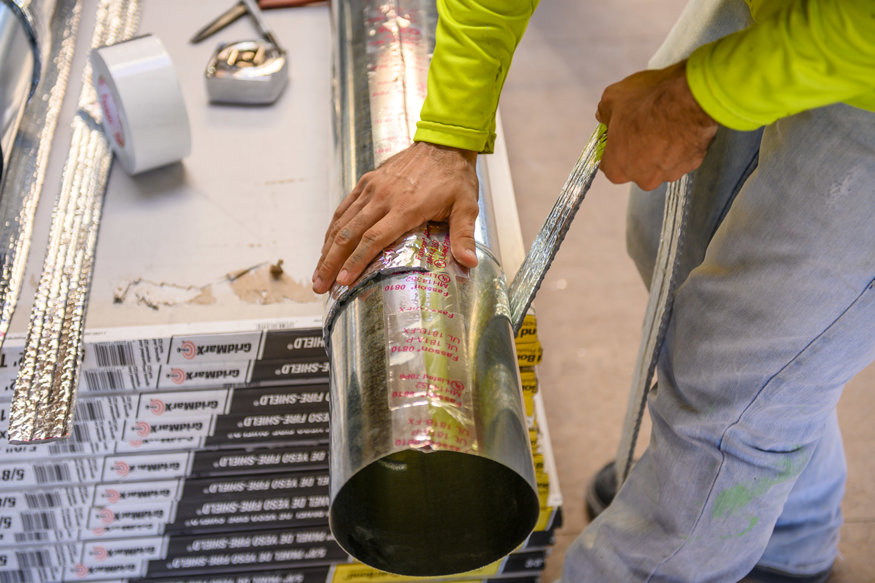 Crew sealing metal duct joints.