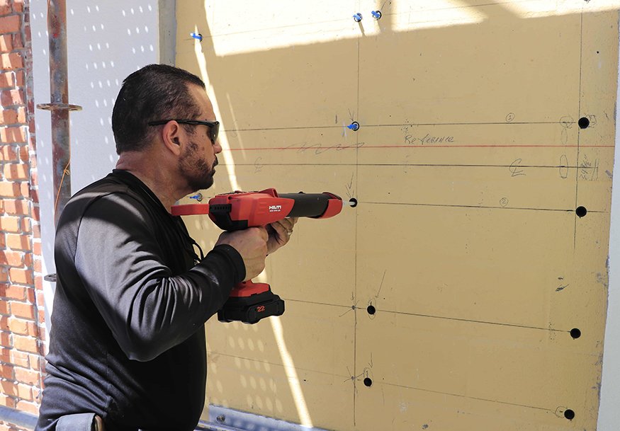 A rotary hammer drill is used ahead of anchor points installation.