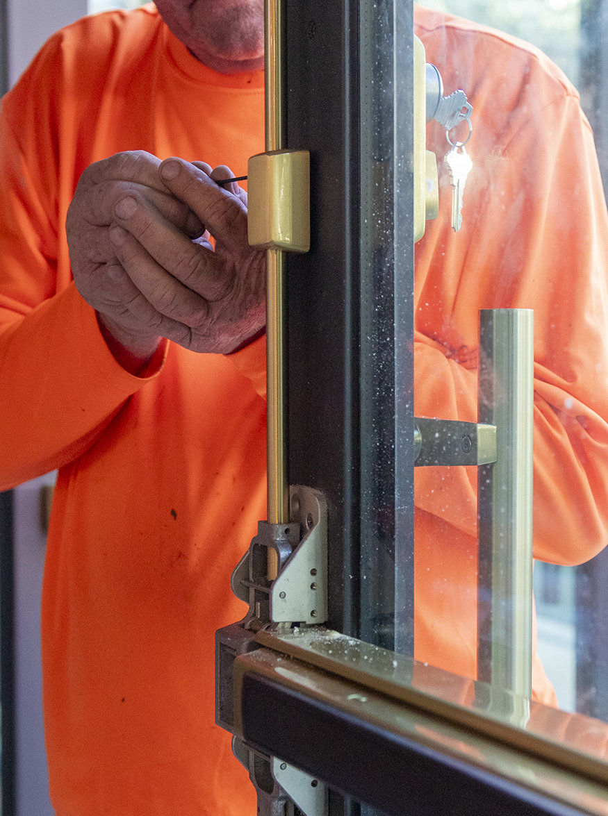 Installing brass door lock.