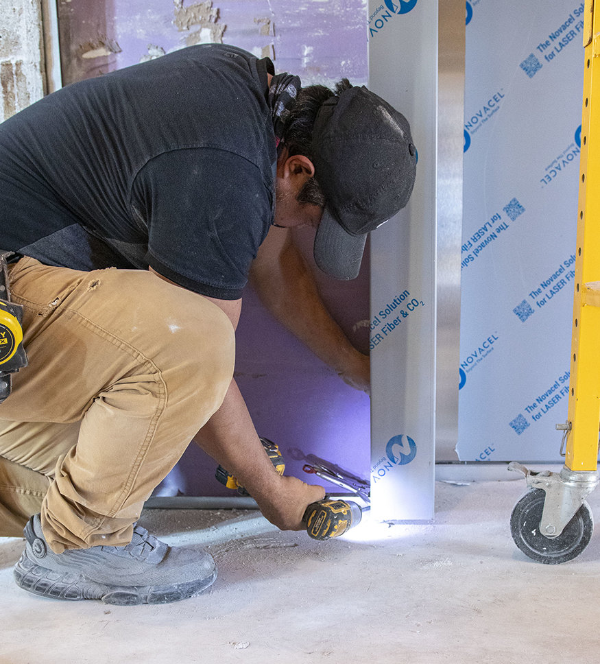 Crews secure the drywall to the framing.