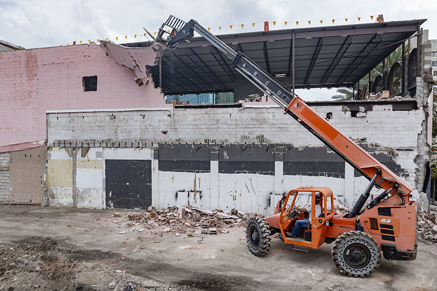 Telehandler removes masonry from upper east elevation at 639 Cleveland Street.